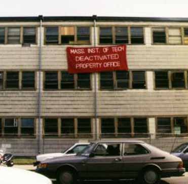 Figure 12 In a student hack, a giant "Deactivated" sticker was put on Building 20 in March 1998 to acknowledge the impending demolition of the building, to be replaced by the Stata Center. The sticker is an oversized replica of those put on any deactivated MIT equipment., digital image, Wikimedia Commons, June 17, 2017.